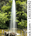 A fountain amidst fresh greenery 140339092