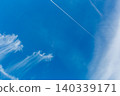 Contrails in the sky during the rainy season; blue sky and clouds. 140339171