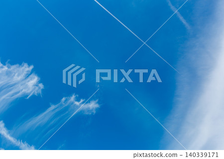 Contrails in the sky during the rainy season; blue sky and clouds. Contrails in the sky during the rainy season; blue sky and clouds. 140339171