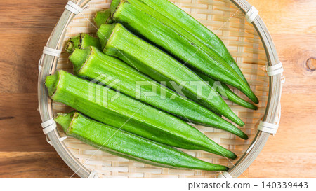 An image of summer vegetables, with fresh okra arranged in a colander. An image of summer vegetables, with fresh okra arranged in a colander. 140339443