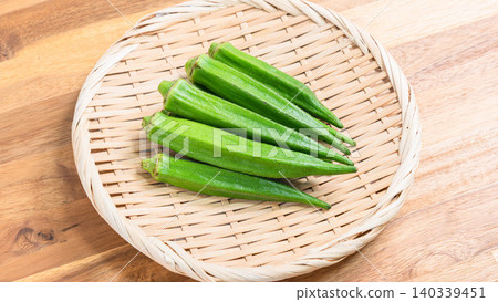 An image of summer vegetables, with fresh okra arranged in a colander. An image of summer vegetables, with fresh okra arranged in a colander. 140339451