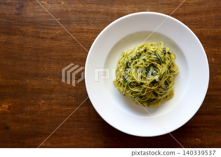 Genovese pasta in the background of a table viewed from directly above. 140339537