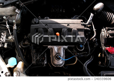 Top-down view of a four-cylinder car engine bay 140339606
