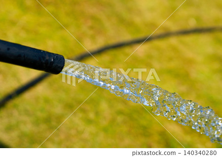 Hot summer.Hose draining water for watering and washing Hot summer.Hose draining water for watering and washing 140340280