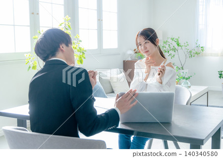 A businessman who consults with a young woman 140340580