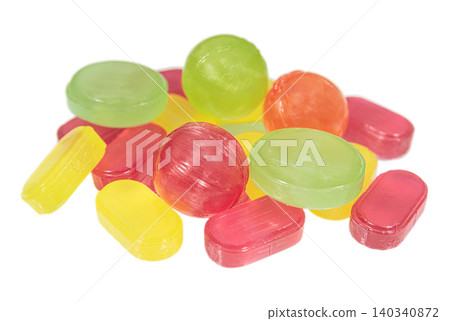 Heap multicolored hard candies on a white background Heap multicolored hard candies on a white background 140340872