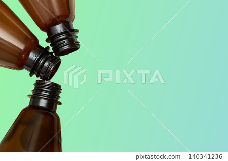 Three empty plastic bottles for alcohol and soda drinks on green gradient Three empty plastic bottles for alcohol and soda drinks on green gradient 140341236