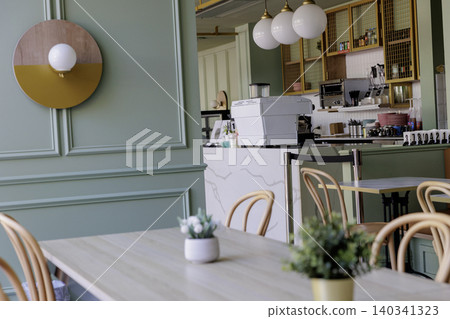 A view of the interior of an empty, stylish cafe. A view of the interior of an empty, stylish cafe. 140341323