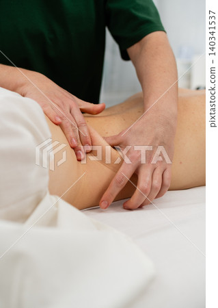 Therapist Performing Lower Back Massage In Spa Therapist Performing Lower Back Massage In Spa 140341537