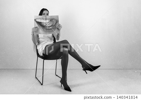 Woman holding magazine with sensual mouth image Woman holding magazine with sensual mouth image 140341814