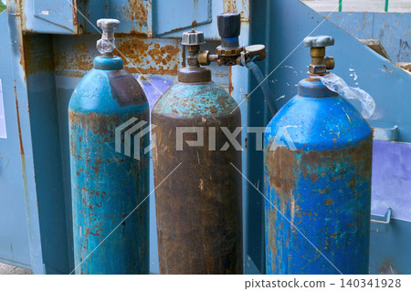 Old cylinders with flammable gas and oxygen for welding cutting metal Old cylinders with flammable gas and oxygen for welding cutting metal 140341928