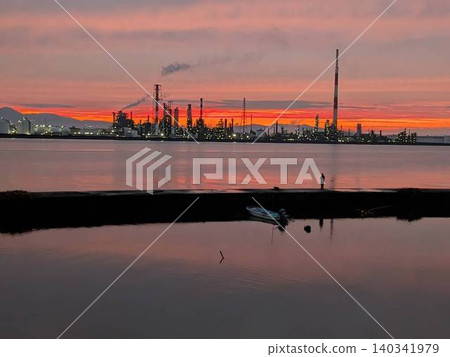 The factory nightscape bathed in the sunset light and its reflection on the water's surface The factory nightscape bathed in the sunset light and its reflection on the water's surface 140341979