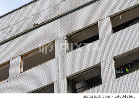 Urban Apartment Building Facade With Tiled Exterior During Renovation and Construction Work 140342663