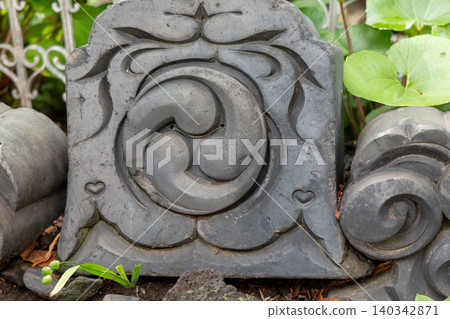 Roof tiles bearing the company's crest of three tomoe (comma-shaped symbols). Roof tiles bearing the company's crest of three tomoe (comma-shaped symbols). 140342871