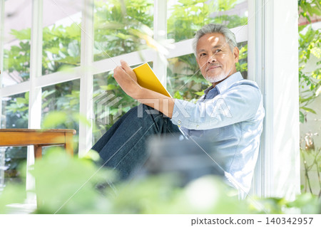 Senior male reading Senior male reading 140342957
