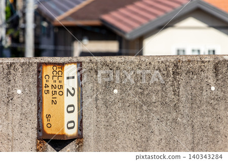 Close-up of a sound barrier and curve marker next to a conventional railway line. 140343284