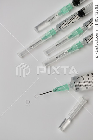 Syringes with needles containing injection solution (1mm and 10mm) - Image of vaccination Syringes with needles containing injection solution (1mm and 10mm) - Image of vaccination 140343581