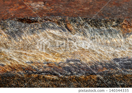 Macro mineral stone Snake eye in the rock a white background Macro mineral stone Snake eye in the rock a white background 140344335