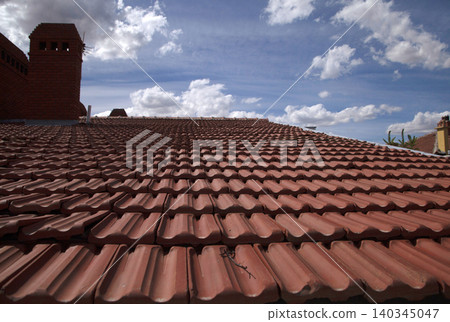 Red roof on blue sky background. Red roof on blue sky background. 140345047