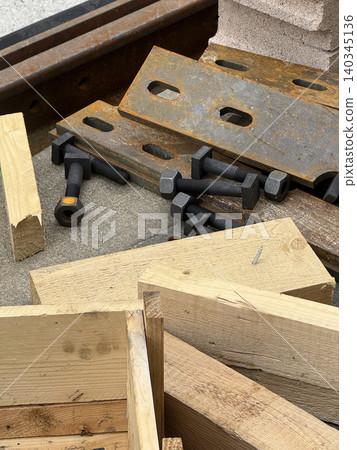 Wooden beams, steel plates and bolts on concrete - construction materials, industrial engineering and building concept Wooden beams, steel plates and bolts on concrete - construction materials, industrial engineering and building concept 140345136