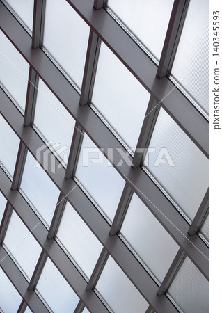 Glass ceiling structure showcasing modern architecture during the day in an urban setting Glass ceiling structure showcasing modern architecture during the day in an urban setting 140345593