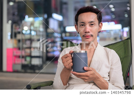 Thai Non-Binary Gay Man Holding Coffee Mug Landscape Portrait Thai Non-Binary Gay Man Holding Coffee Mug Landscape Portrait 140345798