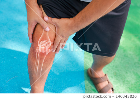 Close up of unrecognizable man suffering from knee joint pain with glowing bone anatomy graphic overlay after rock climbing exercise. Sports injury and medical healthcare concept. Close up of unrecognizable man suffering from knee joint pain with glowing bone anatomy graphic overlay after rock climbing exercise. Sports injury and medical healthcare concept. 140345826