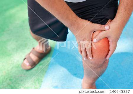 Close up of unrecognizable man suffering from knee joint pain with glowing red graphic overlay on his leg. Muscle cramp, sports injury and medical healthcare concept. Close up of unrecognizable man suffering from knee joint pain with glowing red graphic overlay on his leg. Muscle cramp, sports injury and medical healthcare concept. 140345827
