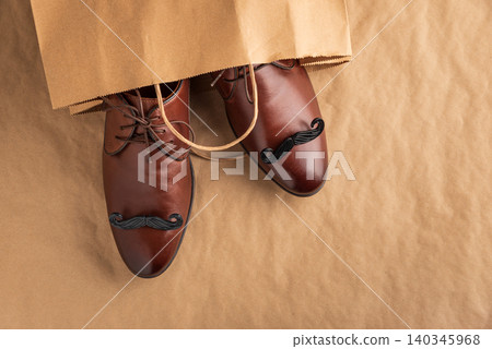 Brown leather shoes with mustaches in a shopping bag Brown leather shoes with mustaches in a shopping bag 140345968
