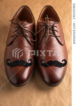 Brown leather shoes with black mustache for Movember and Father's Day 140345969