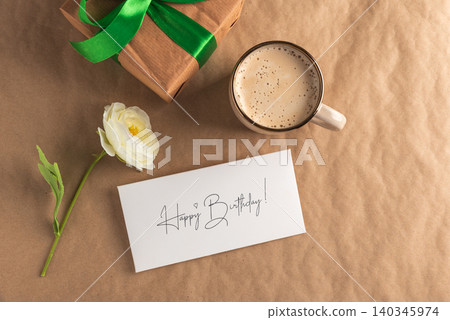 Birthday celebration featuring gift, coffee, flower, and greeting card Birthday celebration featuring gift, coffee, flower, and greeting card 140345974