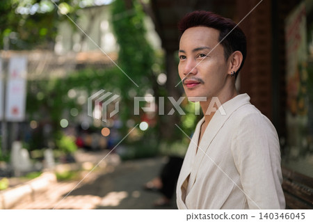 Close Up Lifestyle Portrait of Thai Non-Binary Gay Man Looking Away Outdoors Close Up Lifestyle Portrait of Thai Non-Binary Gay Man Looking Away Outdoors 140346045