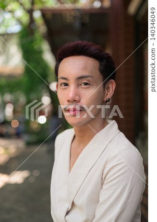 Thai Non-Binary Gay Man Vertical Portrait Looking At Camera Outdoors Thai Non-Binary Gay Man Vertical Portrait Looking At Camera Outdoors 140346049