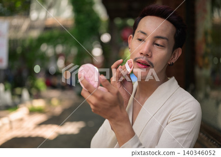 Thai Non-Binary Gay Man Applying Cushion Foundation Landscape Portrait Thai Non-Binary Gay Man Applying Cushion Foundation Landscape Portrait 140346052
