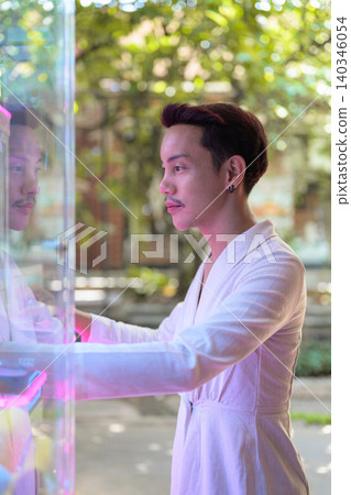 Thai Non-Binary Gay Man Playing Arcade Claw Machine Vertical Portrait Thai Non-Binary Gay Man Playing Arcade Claw Machine Vertical Portrait 140346054