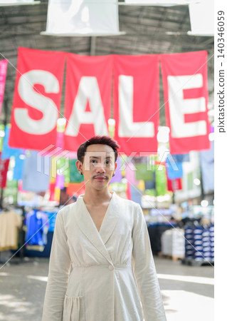 Vertical Medium Portrait of Thai Non-Binary Gay Man at Market Sale Vertical Medium Portrait of Thai Non-Binary Gay Man at Market Sale 140346059