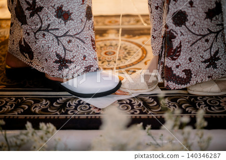 Traditional Indonesian wedding ritual, the egg stepping ceremony. Traditional Indonesian wedding ritual, the egg stepping ceremony. 140346287