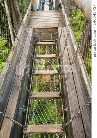 Wooden rope ladder in treetop adventure park Wooden rope ladder in treetop adventure park 140346457
