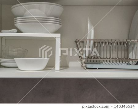 Kitchen cabinet storing dinnerware and dish rack 140346534