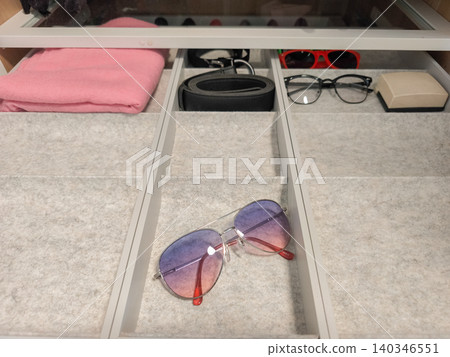Sunglasses and accessories organizing a drawer Sunglasses and accessories organizing a drawer 140346551