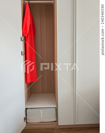 Modern minimalist wardrobe with red dress hanging inside Modern minimalist wardrobe with red dress hanging inside 140346590