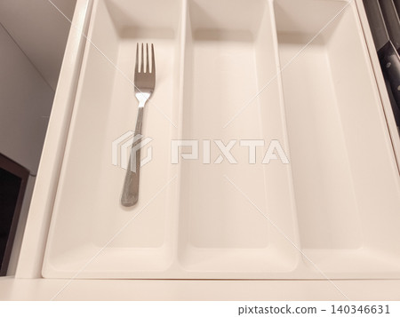 Single fork in empty kitchen cutlery drawer Single fork in empty kitchen cutlery drawer 140346631