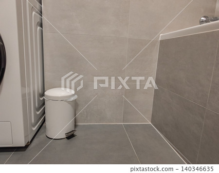 Bathroom interior with washing machine and waste bin Bathroom interior with washing machine and waste bin 140346635