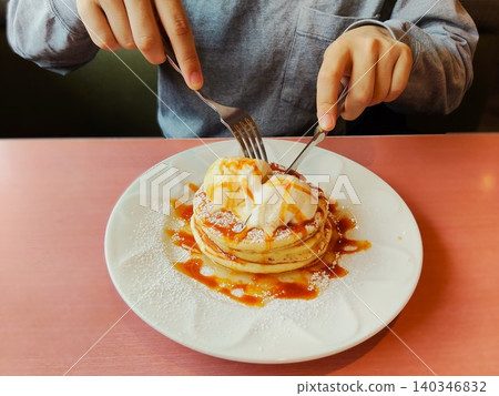 People who eat pancakes with ice cream on them People who eat pancakes with ice cream on them 140346832