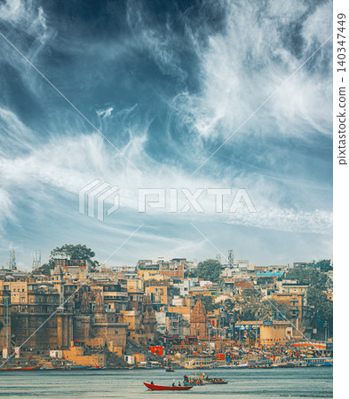 Varanasi Skyline Under Dramatic Clouds. Boats Floating Near Rana Mahal Ghat, Darbhanga Ghat And Dashashwamedh Ghat Varanasi Skyline Under Dramatic Clouds. Boats Floating Near Rana Mahal Ghat, Darbhanga Ghat And Dashashwamedh Ghat 140347449