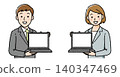 A businessman and a businesswoman showing their laptop screens. 140347469