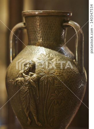 Metal Amphora with Human Figure Engraving Metal Amphora with Human Figure Engraving 140347534