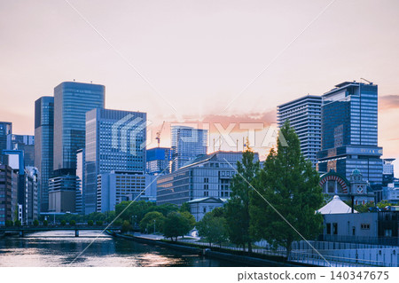 A beautiful urban landscape of Osaka's Nakanoshima skyscrapers and the Dojima River at dusk. A beautiful urban landscape of Osaka's Nakanoshima skyscrapers and the Dojima River at dusk. 140347675