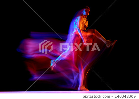Neon basketball player in abstract jump motion on black studio background. Neon basketball player in abstract jump motion on black studio background. 140348309