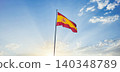 Flag of Spain waving at the top of a post with a bottom of sunny blue sky 140348789
